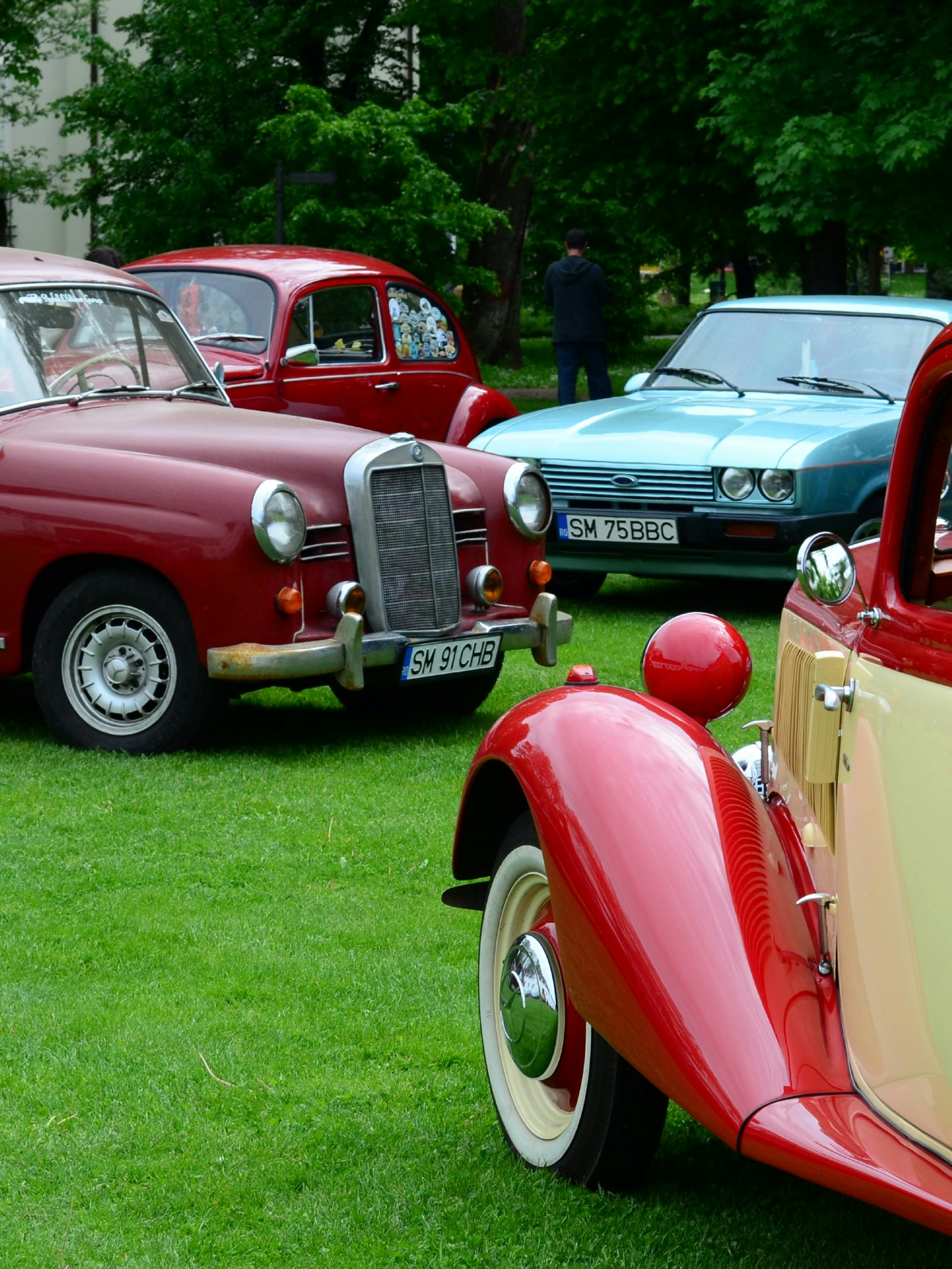 A vibrant display of classic vintage cars at an outdoor exhibition.
