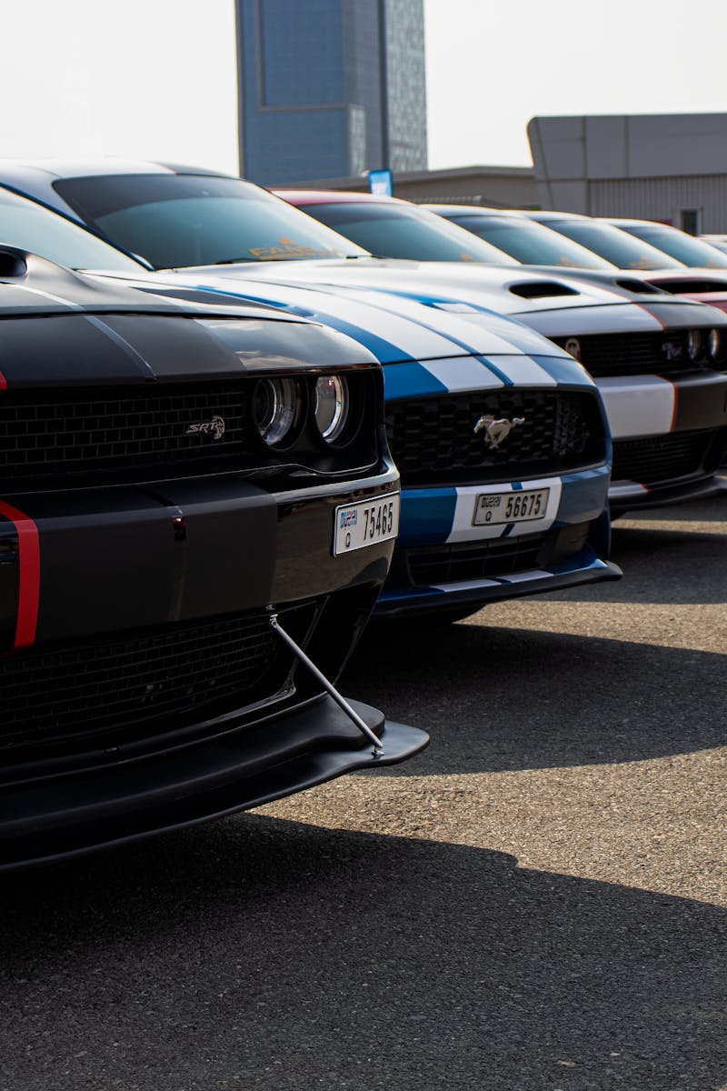 Close-up view of a row of parked sports cars, emphasizing their sleek designs.